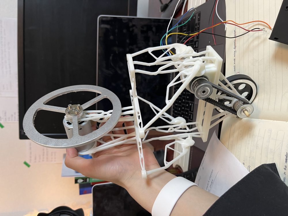 A 3D-printed generative-design chassis held in one hand