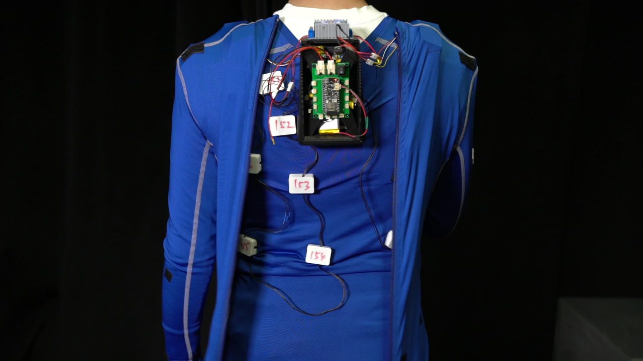 The AeroHaptix suit, back, with the controller and the chained units